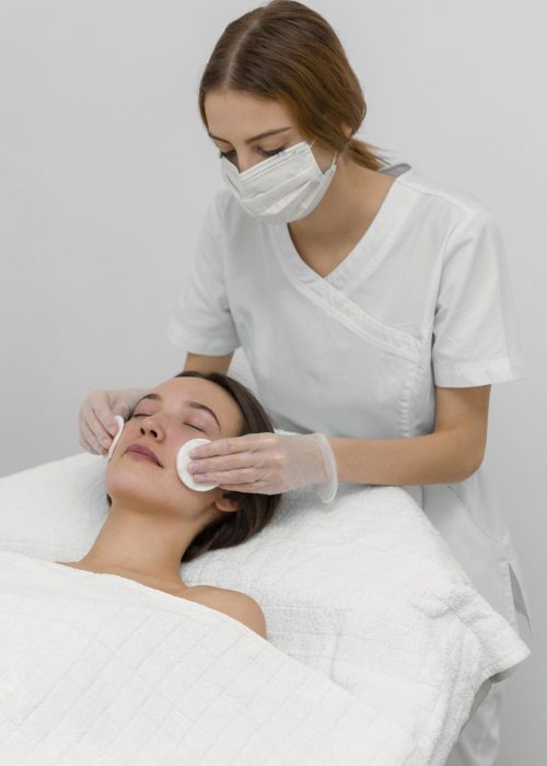 beautician-with-female-client-salon-face-care-routine-with-cleansing-disks